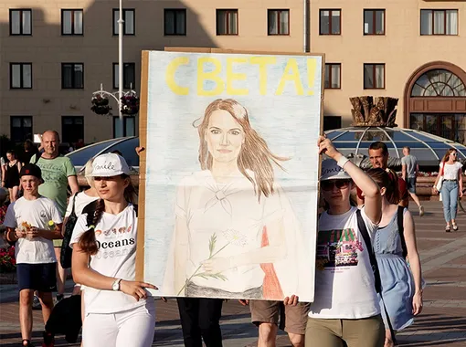 Две женщины несут фотографию Светлана Тихоновской в Минске, август 2020 года Две женщины несут фотографию Светлана Тихоновской в Минске, август 2020 года