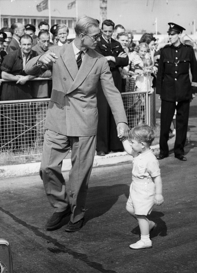 Принц Филипп держит принца Чарльза за руку по прибытии в лондонский аэропорт с Мальты, 27 июля 1951 года.