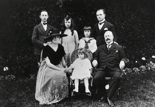 Семья Диор в своем саду, 1920 год. В середине между родителями сидит Кэтрин. Сзади слева направо – Кристиан, Жаклин, Бернар и Раймонд Семья Диор в своем саду, 1920 год. В середине между родителями сидит Кэтрин. Сзади слева направо – Кристиан, Жаклин, Бернар и Раймонд